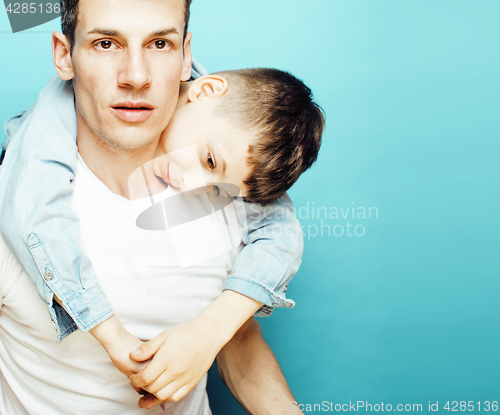 Image of young pretty man model with little cute son playing together, lifestyle modern people concept, family male 