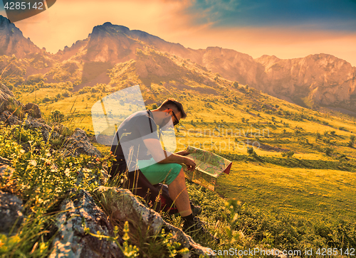 Image of The Hiker with a Map in Misty Mountains