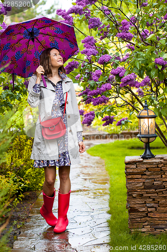 Image of Beautiful woman with an umbrella on a rainy day