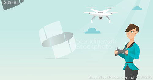 Image of Young caucasian woman flying drone.