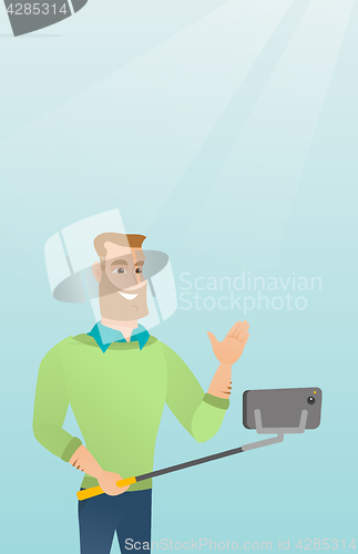 Image of Young caucasian hipster man making selfie.