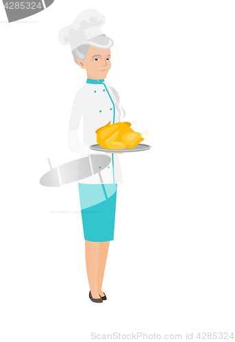 Image of Senior caucasian chef holding roasted chicken.