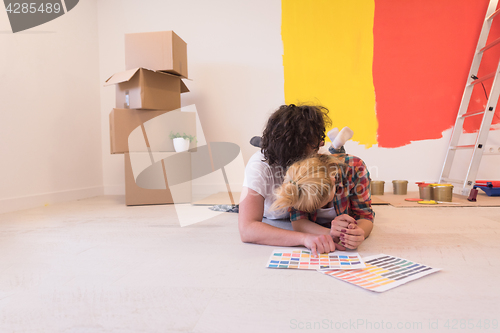 Image of Happy young couple relaxing after painting
