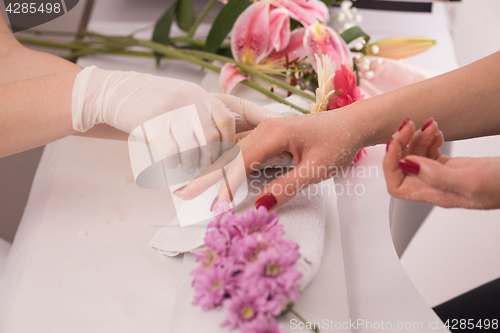 Image of Woman hands receiving a manicure