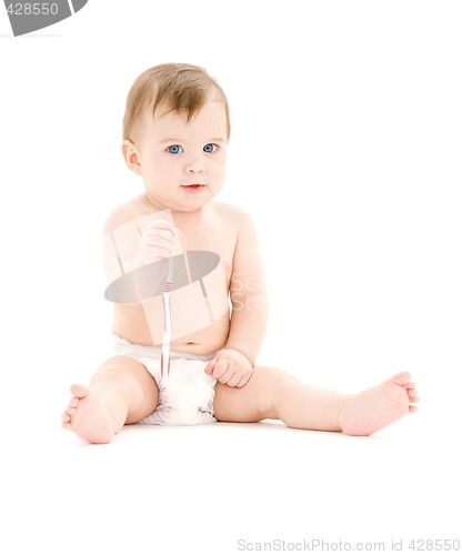 Image of baby boy in diaper with toothbrush