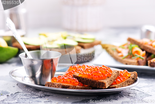 Image of bread with red salmon caviar 