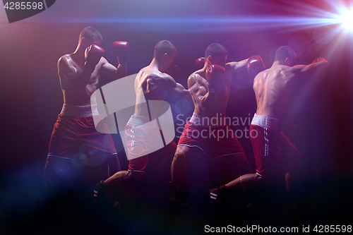 Image of The boxer boxing in a dark studio