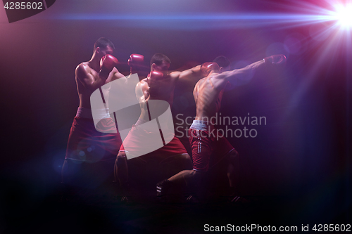 Image of The boxer boxing in a dark studio