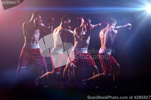 Image of The boxer boxing in a dark studio