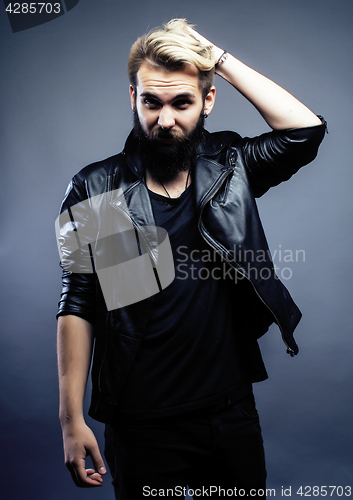 Image of portrait of young bearded hipster guy on gray dark background close up, brutal modern man, lifestyle people concept 