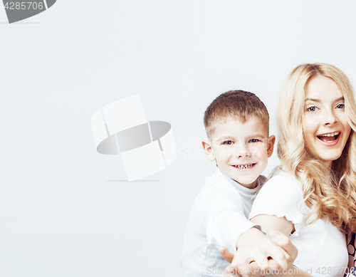 Image of young modern blond curly mother with cute son together happy smiling family posing cheerful on white background, lifestyle people concept, sister and brother friends 