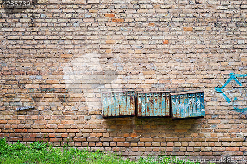 Image of Rusty mailboxes on the brick grunge wall