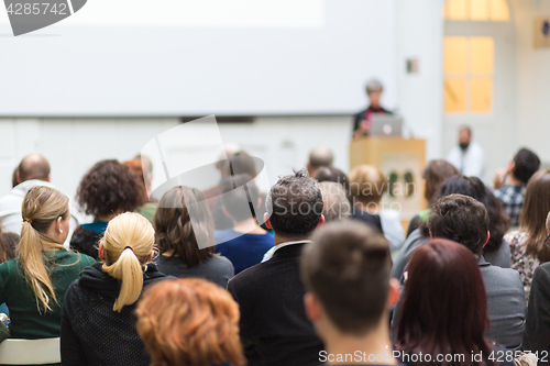 Image of Woman giving presentation in lecture hall at university.