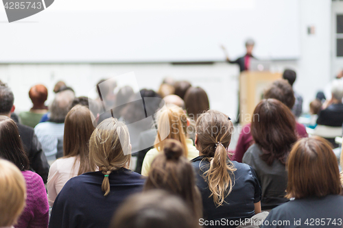 Image of Woman giving presentation in lecture hall at university.