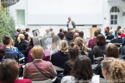 Image of Man giving presentation in lecture hall at university.