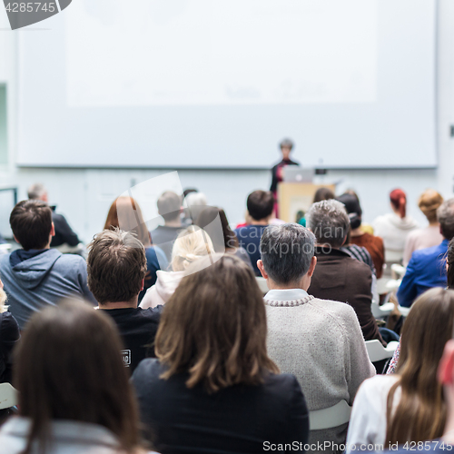 Image of Woman giving presentation in lecture hall at university.