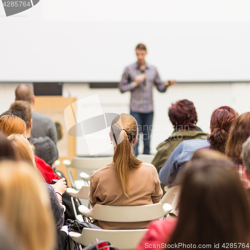 Image of Man giving presentation in lecture hall at university.