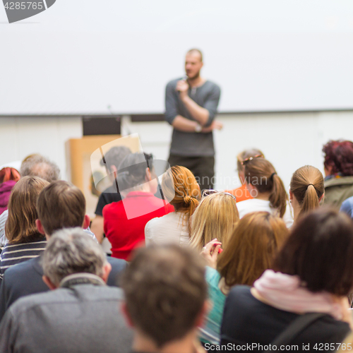 Image of Man giving presentation in lecture hall at university.