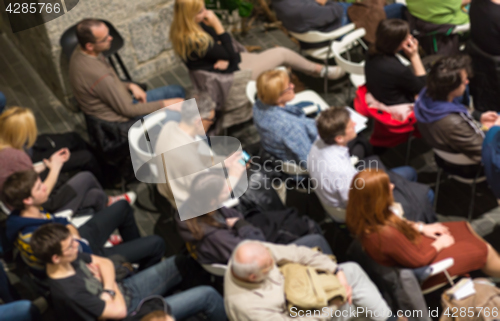 Image of Blured audience in conference hall shot from abowe.