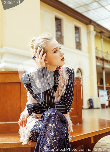 Image of young attractive fashion lady on railway station waiting, vintage people concept in classic interior 