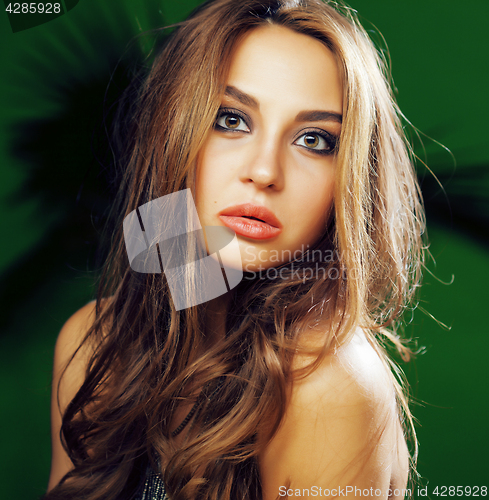 Image of young cute blonde woman on green palm background smiling happy, lifestyle peole concept