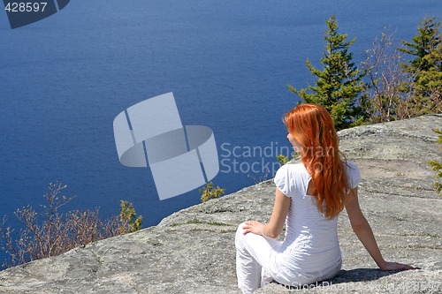 Image of Girl sitting on a rock, enjoying the view