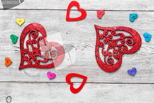 Image of Symbolic hearts on red background