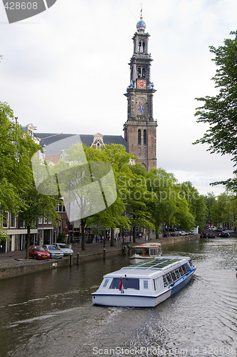 Image of canal scene with tourist boat westekerk amsterdam