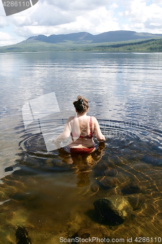 Image of Overweight woman in a lake