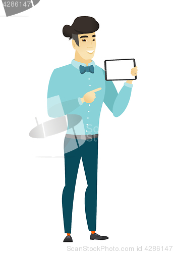 Image of Smiling businessman holding tablet computer.