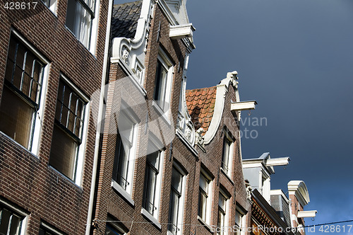 Image of houses with hoist lift mechanism over canal amsterdam holland ne