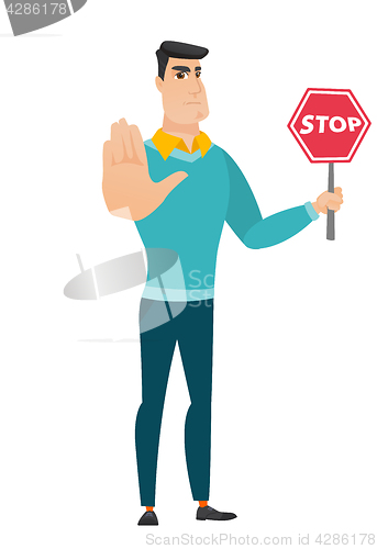 Image of Caucasian businessman holding stop road sign.