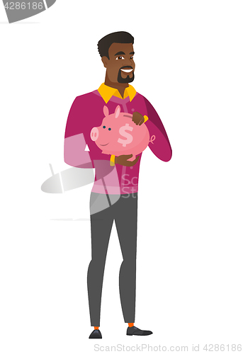 Image of African-american business man holding piggy bank.
