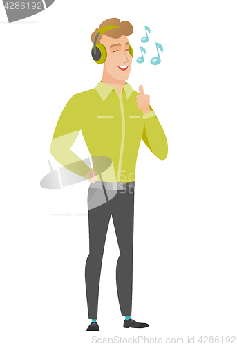 Image of Businessman listening to music in headphones.
