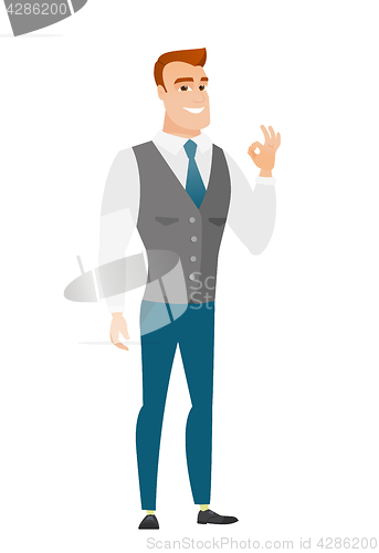 Image of Smiling businessman showing ok sign.