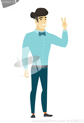 Image of Asian businessman showing the victory gesture.