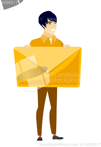 Image of Smiling businessman holding a big envelope.