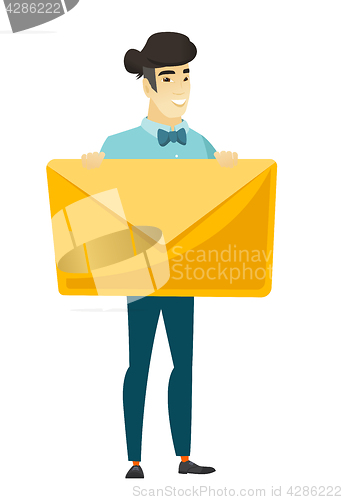 Image of Smiling businessman holding a big envelope.