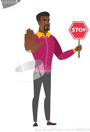 Image of African businessman holding stop road sign.