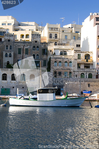 Image of old fishing boat st. julians harbor real estate overdevelopment