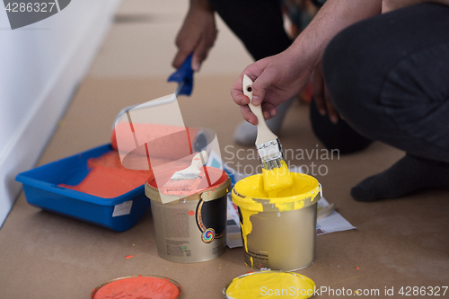 Image of painters prepare color for painting