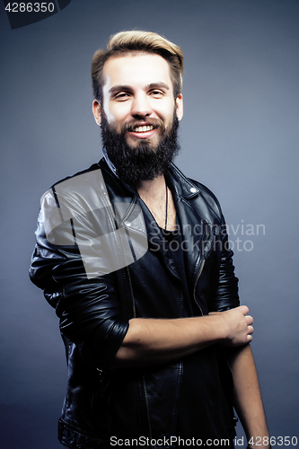 Image of portrait of young bearded hipster guy on gray dark background close up, brutal modern man, lifestyle people concept 