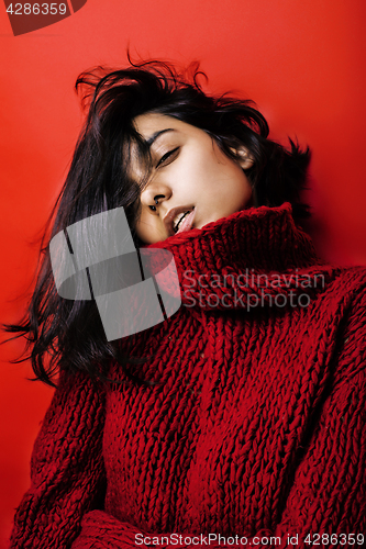 Image of young pretty indian mulatto girl in red sweater posing emotional, fashion hipster teenage, lifestyle people concept