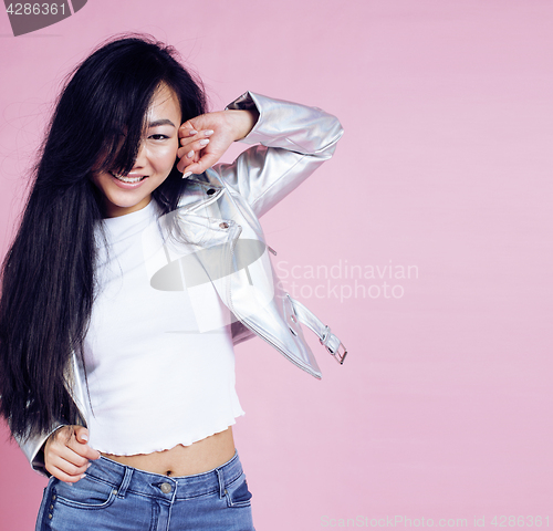 Image of young pretty smiling asian korean girl wearing modern fashion clothers on pink background, lifestyle people concept 