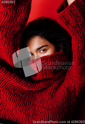 Image of young pretty indian mulatto girl in red sweater posing emotional, fashion hipster teenage, lifestyle people concept