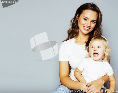 Image of mother with daughter together in bed smiling, happy family close