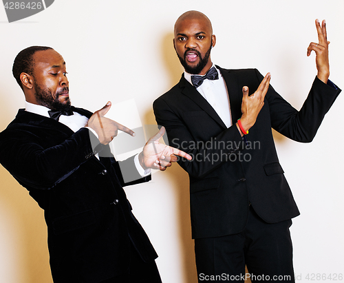 Image of two afro-american businessmen in black suits emotional posing, g