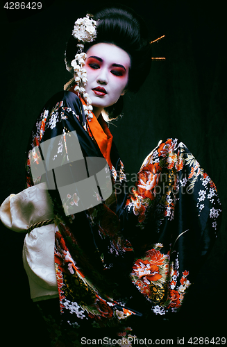 Image of geisha in kimono on black