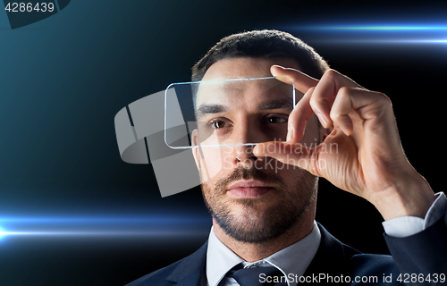 Image of businessman with transparent smartphone