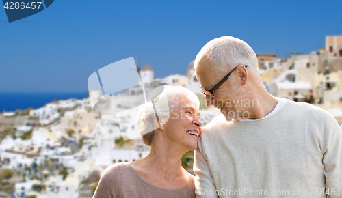 Image of happy senior couple over santorini island